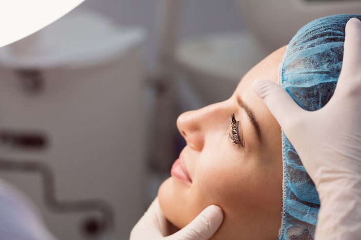 Patient preparing for a nose job consultation in London, receiving a professional facial assessment before rhinoplasty or non-surgical nose reshaping.